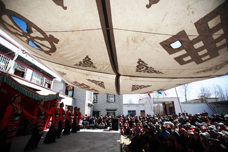 Artists from the Tibetan Drama Troupe of Tibet stage a traditional drama for local villagers to celebrate the upcoming Tibetan New Year in Ngaqen Village of Lhasa, capital of southwest China's Tibet Autonomous Region, on February 20, 2009. The Tibetan New Year falls on February 25 this year according to the traditional Tibetan calendar. 