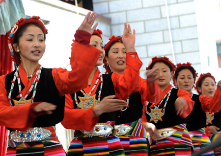 Artists from the Tibetan Drama Troupe perform for local villagers to celebrate the upcoming Tibetan New Year in Ngaqen Village of Lhasa, capital of southwest China's Tibet Autonomous Region, on February 20, 2009.