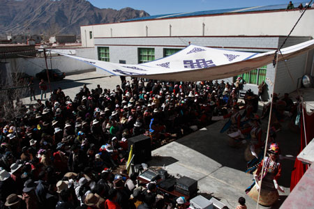 Artists from the Tibetan Drama Troupe of Tibet stage a traditional drama for local villagers to celebrate the upcoming Tibetan New Year in Ngaqen Village of Lhasa, capital of southwest China's Tibet Autonomous Region, on February 20, 2009. 