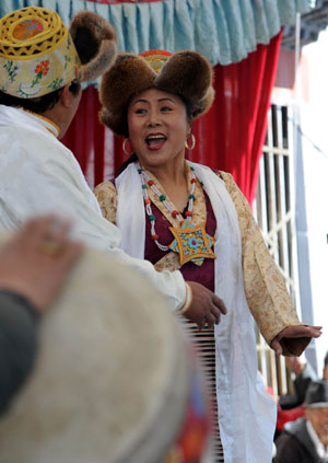 Artists from the Tibetan Drama Troupe of Tibet perform for local villagers to celebrate the upcoming Tibetan New Year in Ngaqen Village of Lhasa, capital of southwest China's Tibet Autonomous Region, on February 20, 2009.