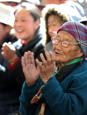 Local villagers watch the performance of artists from the Tibetan Drama Troupe of Tibet to celebrate the upcoming Tibetan New Year in Ngaqen Village of Lhasa, capital of southwest China's Tibet Autonomous Region, on February 20, 2009. 