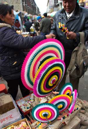 Colored paper flowers, which are offered in front of the Buddhism statue for the Tibetan New Year, are on sale at a market in Lhasa, capital of southwest China's Tibet Autonomous Region, on February 22, 2009. 