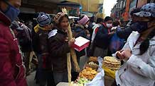 A Tibetan woman buys traditional goods for the Tibetan New Year, at a market in Lhasa, capital of southwest China's Tibet Autonomous Region, on February 22, 2009. Traditional goods for the Tibetan New Year are still popular at the market in Lhasa, as the new year draws near.