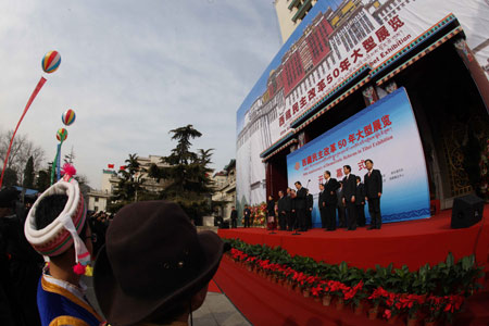 People take part in the opening ceremony of an exhibition marking the 50th anniversary of the Democratic Reform in Tibet Autonomous Region in Beijing, China, on February 24, 2009. 