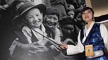 A guide introduces a photo in an exhibition marking the 50th anniversary of the Democratic Reform in Tibet Autonomous Region in Beijing, China, on February 24, 2009.