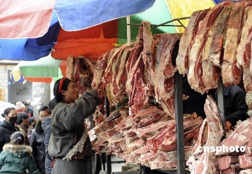 A local resident checks out beef for their coming Tibetan New Year at a bazaar near the Ramoche Temple in Lhasa, in Tibet Autonomous Region on February 23, 2009. Residents in Lhasa are preparing for the Tibetan New Year which falls on February 25. 