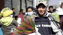 A young man in Lhasa, capital city of southwest China's Tibet Autonomous Region, carries home on Monday a bunch of colored spikes, a traditional decoration for the Tibetan New Year, which falls on February 25, on the Tibetan lunar calendar.