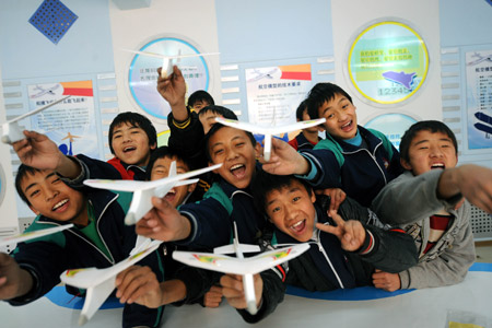 Tibetan students show their model planes in Jinan Tibetan School in Jinan, capital of east China's Shandong Province, on February 24, 2009. 