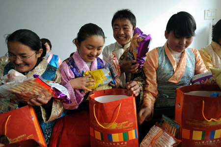 Tibetan students unpack the gifts from local people before the Tibetan New Year which falls on February 25 this year at Jinan Tibetan School in Jinan, capital of east China's Shandong Province, on February 24, 2009. 