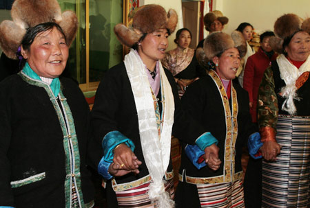 Local villagers perform Tibetan Bonfire Dance, also known as the dance of 'Guozhuang', the traditional greeting dance, during a ceremony to celebrate the Tibetan New Year in Gaba Village in east Lhasa, capital of southwest China's Tibet Autonomous Region, on February 25, 2009.