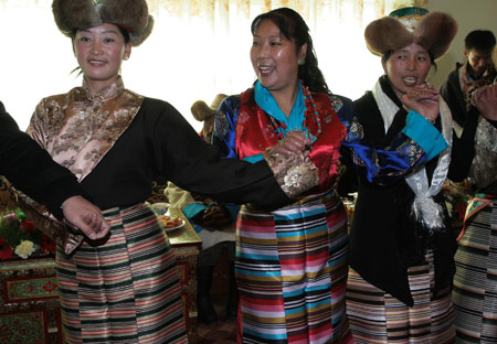 Local villagers perform Tibetan Bonfire Dance, also known as the dance of 'Guozhuang', the traditional greeting dance, during a ceremony to celebrate the Tibetan New Year in Gaba Village in east Lhasa, capital of southwest China's Tibet Autonomous Region, on February 25, 2009.