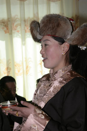 A local villager sings a song to toast a drink during a ceremony to celebrate the Tibetan New Year in Gaba Village in east Lhasa, capital of southwest China's Tibet Autonomous Region, on February 25, 2009.