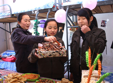 Students of Tibetan ethnic group enjoy traditional food on the first day of Tibetan new year at Liaoyang First High School in north China's Liaoning Province on February 25, 2009. Tibetans across China are celebrating the 50th Tibetan New Year after the Democratic Reform with their old traditions. 