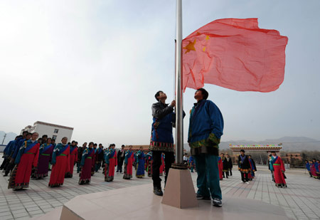 Students salute at the national flag-raising ceremony on the first day of new semester in the School for Nationalities in Tianzhu Tibet Autonomous County, northwest China's Gansu Province, Feb. 25, 2009. Tibetans across China are celebrating the 50th Tibetan New Year after the Democratic Reform with their old traditions. 