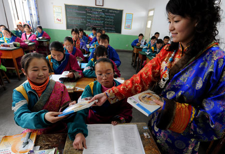 Students receive free textbooks on the first day of new semester in the School for Nationalities in Tianzhu Tibet Autonomous County, northwest China's Gansu Province, on February 25, 2009. Tibetans across China are celebrating the 50th Tibetan New Year after the Democratic Reform with their old traditions. 