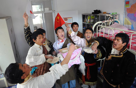 Students of Tibetan ethnic group cheers in their dormitory to celebrate the Tibetan New Year at Tibetan School in Jinan, capital of east China's Shandong Province, on February 25, 2009. Tibetans across China are celebrating the 50th Tibetan New Year after the Democratic Reform with their old traditions. 