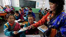 Students receive free textbooks on the first day of new semester in the School for Nationalities in Tianzhu Tibet Autonomous County, northwest China's Gansu Province, on February 25, 2009. Tibetans across China are celebrating the 50th Tibetan New Year after the Democratic Reform with their old traditions.