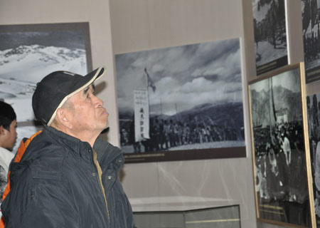 A visitor looks at a pricture at an exhibition marking the 50th anniversary of the Democratic Reform in Tibet Autonomous Region in Beijing, on February 25, 2009. The exhibition opened on February 24 and runs until April 10.