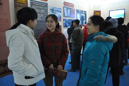 Photo taken on February 26, 2009 shows a college student and her mother talk to Xhinhuanet on their feelings at the 50th Anniversary of Democratic Reforms in Tibet Exhibition, which runs from February 24 to April 10 in the Exhibition Center of the Cultural Palace of Nationalities, Beijing. 