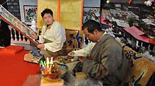 Tibetan craftsmen create butter sculptures at the 50th Anniversary of Democratic Reforms in Tibet Exhibition, which runs from February 24 to April 10 in the Exhibition Center of the Cultural Palace of Nationalities, Beijing.