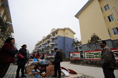 Several villagers sell commodities at Shibei New Village of Xiang'e Township in Dujiangyan City, southwest China's Sichuan Province, on February 25, 2009. 