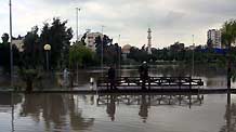 Palestanian people walk through the flooded street after a rainstorm in Gaza City, on March 1, 2009.