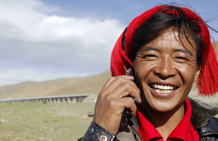 A herdsman of the Tibetan ethnic group talks on the mobile phone in northern Tibet Autonomous Region on June 26, 2008.
