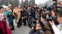 Journalists take photos of the members of the 11th National Committee of the Chinese People's Political Consultative Conference (CPPCC) outside the Great Hall of the People in Beijing, capital of China, March 3, 2009. The Second Session of the 11th CPPCC National Committee opens on Tuesday.