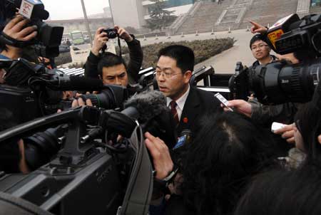 A spokesman of Shijiazhuang Intermediate People's Court is interviewed by media after an auction of scandal-hit Sanlu dairy company in Shijiazhuang, capital of north China's Hebei Province, on March 4, 2009. Beijing-based dairy producer Sanyuan won the bid of Sanlu with the price of 616.5 million yuan (about US$90 million).