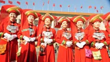 Attendants take photos with a foreigner outside the Great Hall of the People in Beijing, capital of China, on March 5, 2009. The Second Session of the 11th National People's Congress (NPC) opened on Thursday.