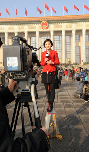 Journalists work at Tian'anmen Square in Beijing, capital of China, on March 5, 2009. The Second Session of the 11th National People's Congress (NPC) opens on Thursday. 