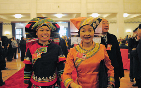 Delegates wearing traditional costumes attend the Second Session of the 11th National People's Congress (NPC) at the Great Hall of the People in Beijing on March 5, 2009. China's parliament, the National People's Congress, opened its annual session on Thursday, with Premier Wen Jiabao giving his work report and spelling out broad policy goals for 2009. 