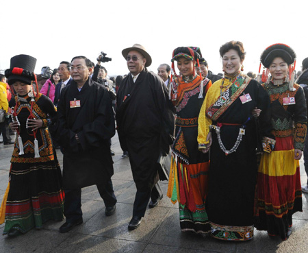 Deputies dressed in traditional costumes walk into the Great Hall of the People to attend the Second Session of the 11th National People's Congress (NPC) in Beijing, on March 5, 2009.