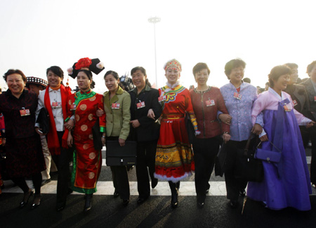 Deputies walk into the Great Hall of the People to attend the opening meeting of the Second Session of the 11th National People's Congress in Beijing, on March 5, 2009.