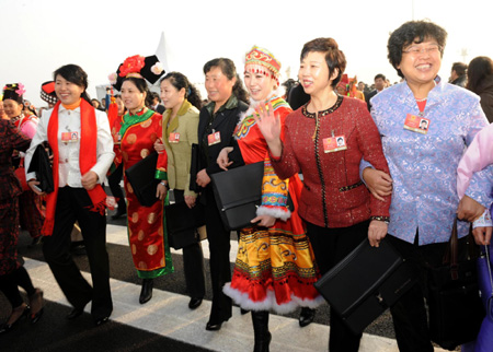 Deputies walk into the Great Hall of the People to attend the opening meeting of the Second Session of the 11th National People's Congress in Beijing, on March 5, 2009. 