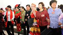 Deputies walk into the Great Hall of the People to attend the opening meeting of the Second Session of the 11th National People's Congress in Beijing, on March 5, 2009.