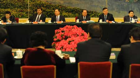 Deputies to the Second Session of the 11th National People's Congress (NPC) from northwest China's Xinjiang Uygur Autonomous Region deliberate the government work report at the Great Hall of the People in Beijing, capital of China, on March 6, 2009. 