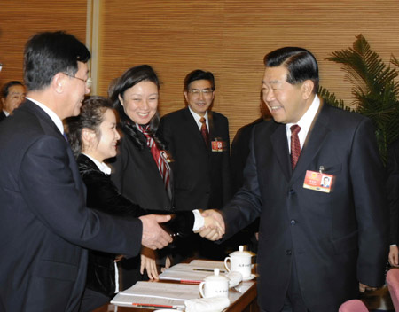 Jia Qinglin (R), member of the Standing Committee of the Political Bureau of the Communist Party of China (CPC) Central Committee and also chairman of the National Committee of the Chinese People's Political Consultative Conference (CPPCC), meets with deputies from Beijing to the Second Session of the 11th National People's Congress (NPC) in Beijing, capital of China, on March 5, 2009. Jia Qinglin joined in the panel discussion of Beijing delegation on the opening day of the Second Session of the 11th NPC. 