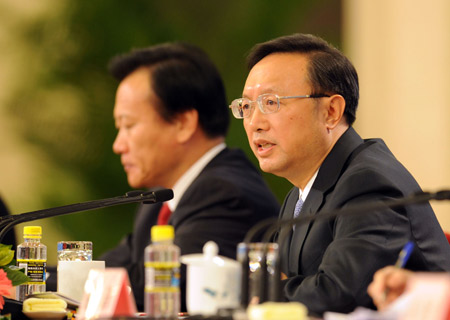 Chinese Foreign Minister Yang Jiechi (R) answers questions during a press conference held by the Second Session of the 11th National People's Congress (NPC) at the Great Hall of the People in Beijing, China, March 7, 2009. 