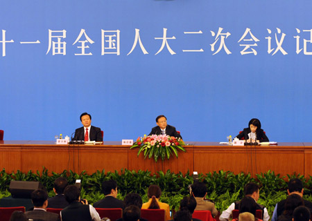 Chinese Foreign Minister Yang Jiechi (C) answers questions during a press conference held by the Second Session of the 11th National People's Congress (NPC) at the Great Hall of the People in Beijing, China, March 7, 2009. 