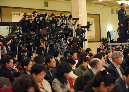 Journalists work during Chinese Foreign Minister Yang Jiechi's meeting with the press held by the Second Session of the 11th National People's Congress (NPC) at the Great Hall of the People in Beijing, China, on March 7, 2009. 