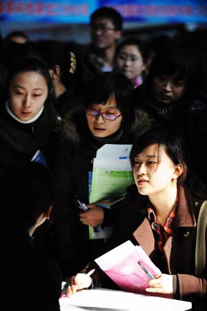 University graduates seek for job opportunities at a job fair in Harbin, capital of northeast China's Heilongjiang Province, on March 7, 2009. Harbin on Saturday held the job fair specifically university graduates, providing more than 6,000 job opportunities. 