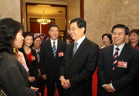 Chinese President Hu Jintao (front, 2nd R) talks to female deputies during the panel discussion of deputies to the Second Session of the 11th National People's Congress (NPC) from south China's s Guangdong Province as International Women's Day is coming, in Beijing, capital of China, on March 7, 2009. 