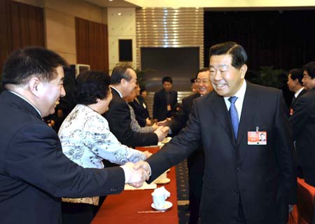 Jia Qinglin (front R), member of the Standing Committee of the Political Bureau of the Communist Party of China (CPC) Central Committee and also chairman of the National Committee of the Chinese People's Political Consultative Conference (CPPCC), meets with members of the 11th National Committee of the CPPCC from the Communist Youth League of China, the All-China Youth Federation, the All-China Federation of Trade Unions and All-China Women's Federation, in Beijing, capital of China, on March 7, 2009.