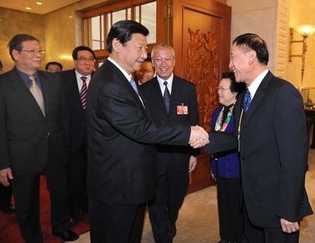 Chinese Vice President Xi Jinping (front L), who is also a member of the Standing Committee of the Political Bureau of the Communist Party of China (CPC) Central Committee, attends the panel discussion of deputies to the Second Session of the 11th National People's Congress (NPC) from south China's Hong Kong Special Administrative Region, in Beijing, capital of China, on March 7, 2009.