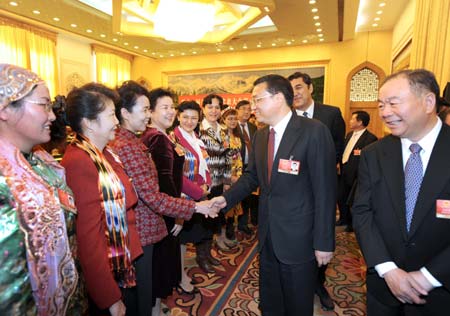 Li Keqiang (front, 2nd R), member of the Standing Committee of the Political Bureau of the Communist Party of China (CPC) Central Committee, attends the panel discussion of deputies to the Second Session of the 11th National People's Congress (NPC) from northwest China's Xinjiang Uygur Autonomous Region, in Beijing, capital of China, on March 7, 2009.