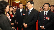 Chinese President Hu Jintao (front, 2nd R) talks to female deputies during the panel discussion of deputies to the Second Session of the 11th National People's Congress (NPC) from south China's s Guangdong Province as International Women's Day is coming, in Beijing, capital of China, on March 7, 2009.