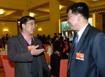 Xie Wei (R) and Wang Jian, members of the 11th National Committee of the Chinese People's Political Consultative Conference (CPPCC), chat prior to the fourth plenary meeting of the Second Session of the 11th National Committee of the CPPCC held at the Great Hall of the People in Beijing, capital of China, on March 9, 2009. 