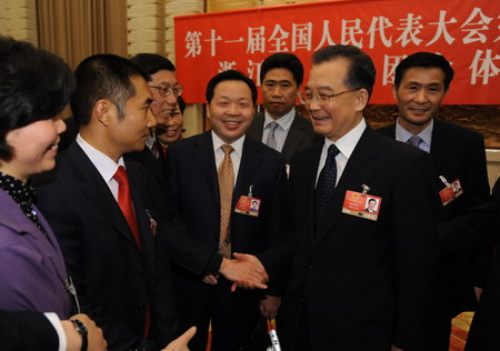 Chinese Premier Wen Jiabao visits deputies from Zhejiang Province in a panel discussion during the annual parliament session in Beijing on March 9, 2009. 