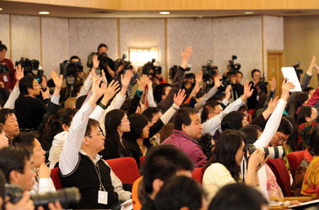 Journalists raise their hands to ask questions during a press conference on 'Boost domestic demand, increase employment and sustain economic growth' held by the Second Session of the 11th National People's Congress (NPC) at the Great Hall of the People in Beijing, capital of China, on March 10, 2009. Minister of Industry and Information Technology Li Yizhong, Minister of Human Resources and Social Security Yin Weimin and Minister of Commerce Chen Deming attended the press conference. 